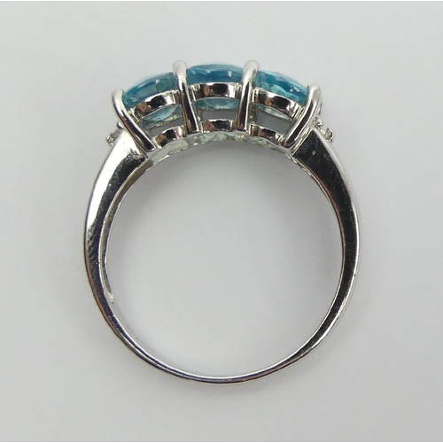 15 - 9ct white gold three stone blue topaz ring, 2.8 grams, 7.3mm wide, Size N1/2