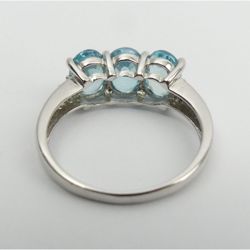 15 - 9ct white gold three stone blue topaz ring, 2.8 grams, 7.3mm wide, Size N1/2