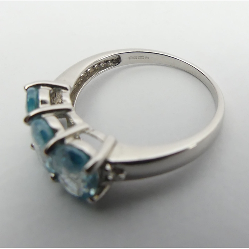 15 - 9ct white gold three stone blue topaz ring, 2.8 grams, 7.3mm wide, Size N1/2