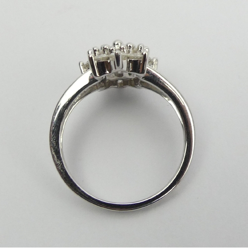 6 - 9ct white gold diamond, (approx .6ct) cluster ring, 3.8 grams, Size N1/2, 15mm wide. UK Postage £12