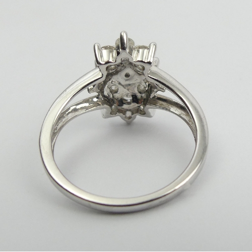 6 - 9ct white gold diamond, (approx .6ct) cluster ring, 3.8 grams, Size N1/2, 15mm wide. UK Postage £12