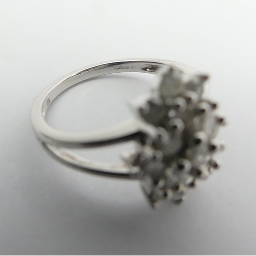 6 - 9ct white gold diamond, (approx .6ct) cluster ring, 3.8 grams, Size N1/2, 15mm wide. UK Postage £12