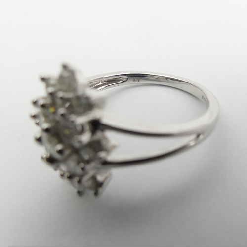 6 - 9ct white gold diamond, (approx .6ct) cluster ring, 3.8 grams, Size N1/2, 15mm wide. UK Postage £12