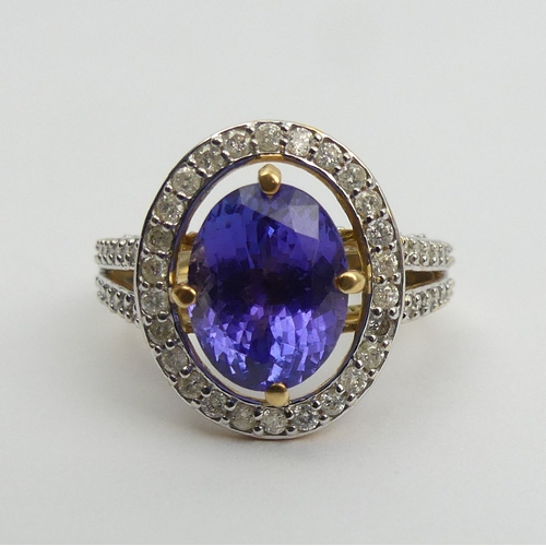 7 - 18ct gold oval tanzanite diamond halo ring with diamond set shoulders, 6.5 grams 
Size N1/2. UK Post... 