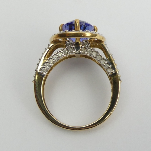 7 - 18ct gold oval tanzanite diamond halo ring with diamond set shoulders, 6.5 grams 
Size N1/2. UK Post... 