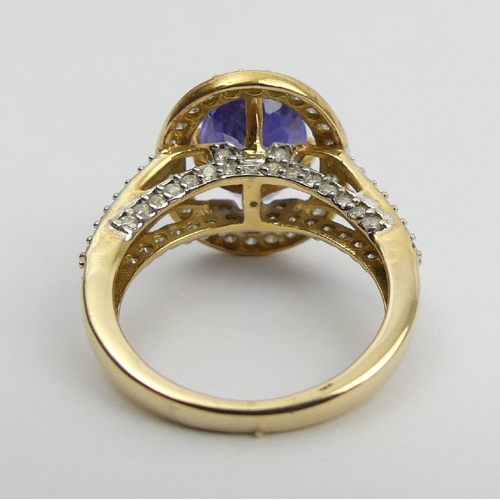 7 - 18ct gold oval tanzanite diamond halo ring with diamond set shoulders, 6.5 grams 
Size N1/2. UK Post... 