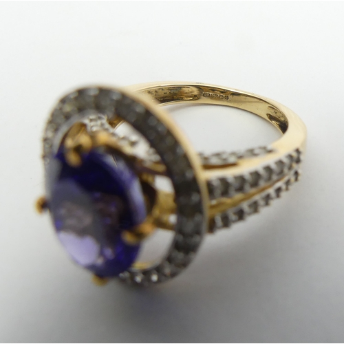 7 - 18ct gold oval tanzanite diamond halo ring with diamond set shoulders, 6.5 grams 
Size N1/2. UK Post... 