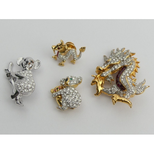 35 - Three Swarovski crystal brooches and a dragon pin, largest dragon brooch 50mm. UK Postage £12.