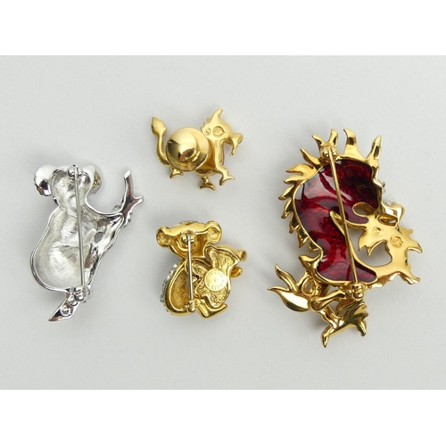 35 - Three Swarovski crystal brooches and a dragon pin, largest dragon brooch 50mm. UK Postage £12.