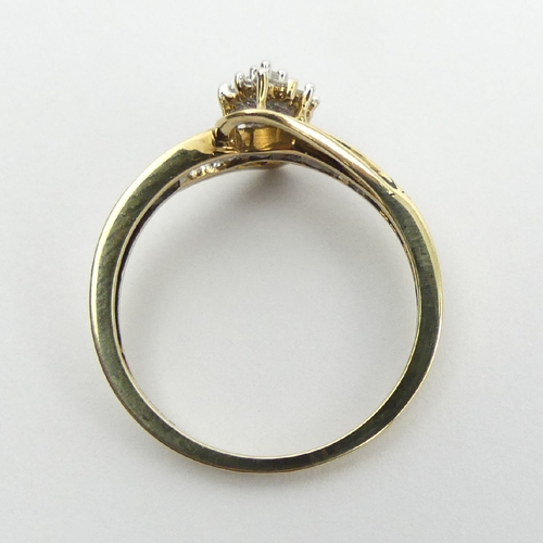 72 - 9ct gold cluster ring, with diamond set shoulders, 2.1 grams, 9.7mm, Size N1/2. UK Postage £12.