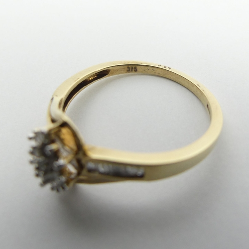 72 - 9ct gold cluster ring, with diamond set shoulders, 2.1 grams, 9.7mm, Size N1/2. UK Postage £12.