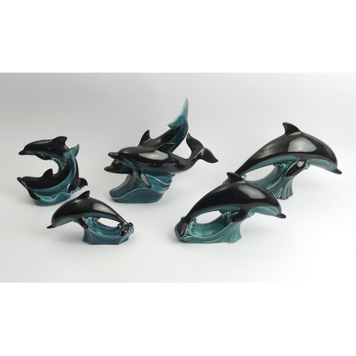 220 - Five Poole pottery dolphin figures, largest 23cm high. UK Postage £15.