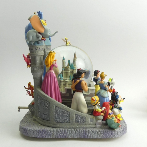 226 - Disney castle musical snow globe with all the Disney Characters, 26cm high. UK Postage £20.