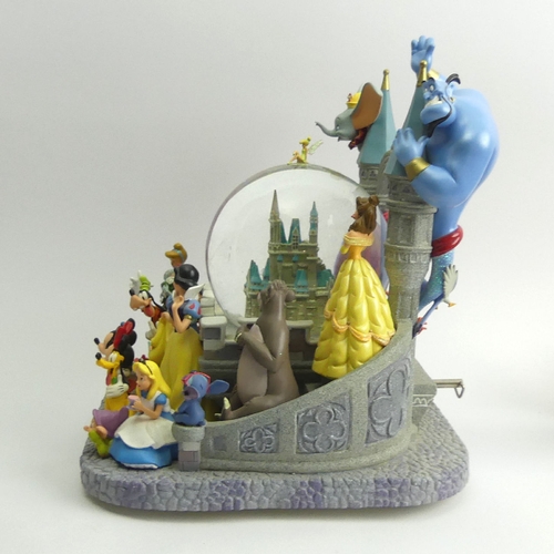 226 - Disney castle musical snow globe with all the Disney Characters, 26cm high. UK Postage £20.