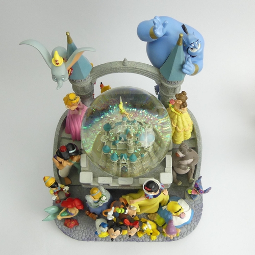 226 - Disney castle musical snow globe with all the Disney Characters, 26cm high. UK Postage £20.