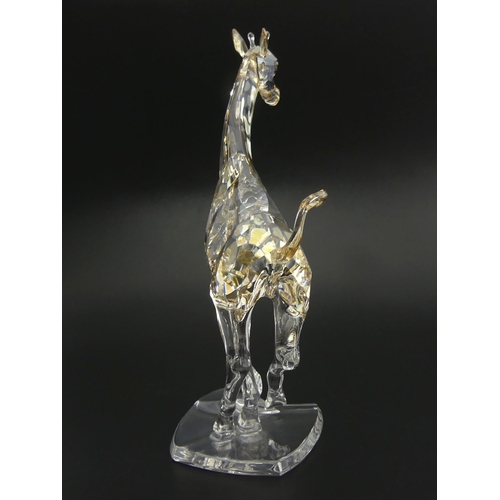 268 - Swarovski Giraffe Running 935896 with box and certificate, 17.5cm. UK Postage £14.