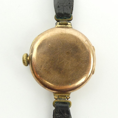 83 - 1920's 9ct gold watch on a leather strap, 27mm wide including button. UK Postage £12.