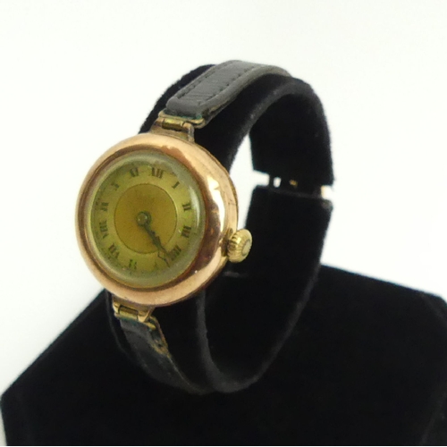 83 - 1920's 9ct gold watch on a leather strap, 27mm wide including button. UK Postage £12.