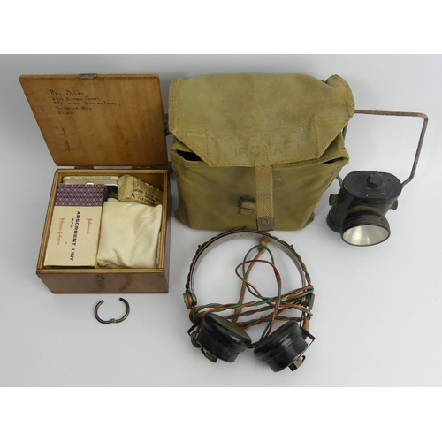 142 - Army first aid kit, a pair of old headphones and an old cycle lamp. UK Postage £12.