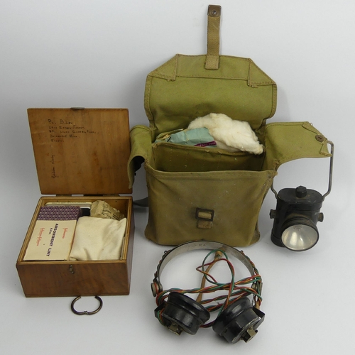 142 - Army first aid kit, a pair of old headphones and an old cycle lamp. UK Postage £12.