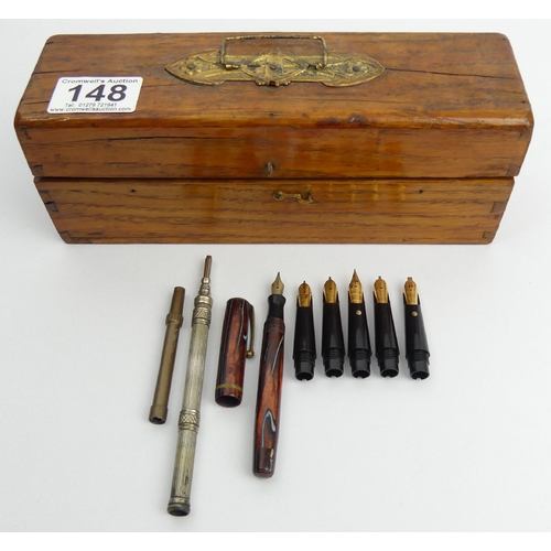 148 - An oak cased early 20th century inkwell set, a Parker Moderne pen, spare nib ends and a propelling p... 