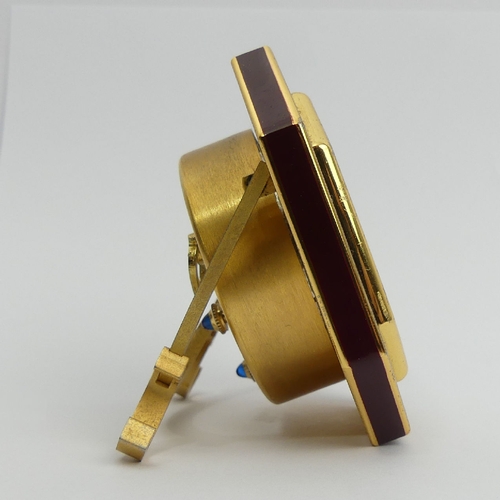 169 - Cartier gilt and maroon travel alarm clock, 7.5cm high. UK Postage £12.
Condition Report: Working Or... 