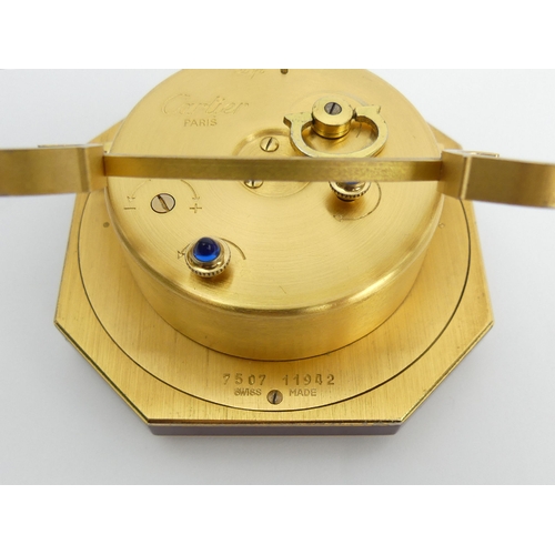 169 - Cartier gilt and maroon travel alarm clock, 7.5cm high. UK Postage £12.
Condition Report: Working Or... 