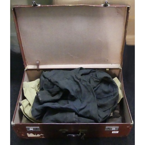 121 - An old suitcase containing a pair of RAF boots along with a uniform and tunic. UK Postage £22.