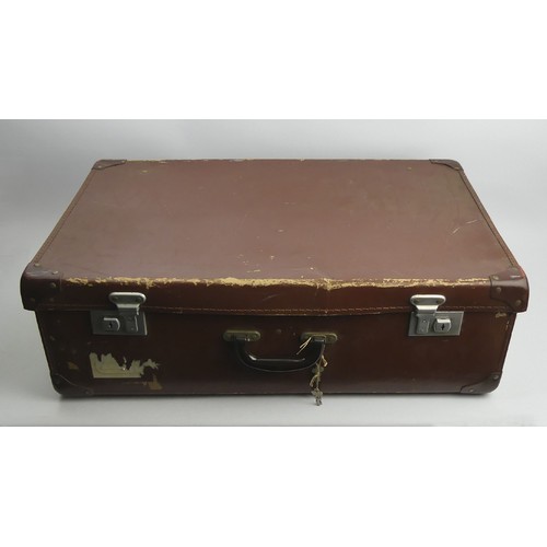 121 - An old suitcase containing a pair of RAF boots along with a uniform and tunic. UK Postage £22.