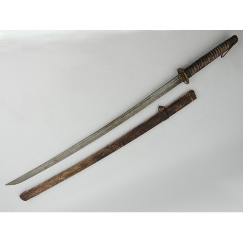 135 - A Japanese, believed to be, World War II Kutana with scabbard, the top of the blade with inscribed c... 