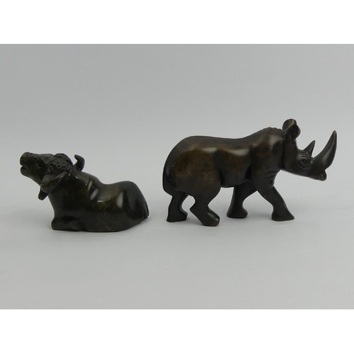 173 - A carved soapstone figure of a rhino and a soapstone figure of a water buffalo, rhino 9.5cm high x 1... 