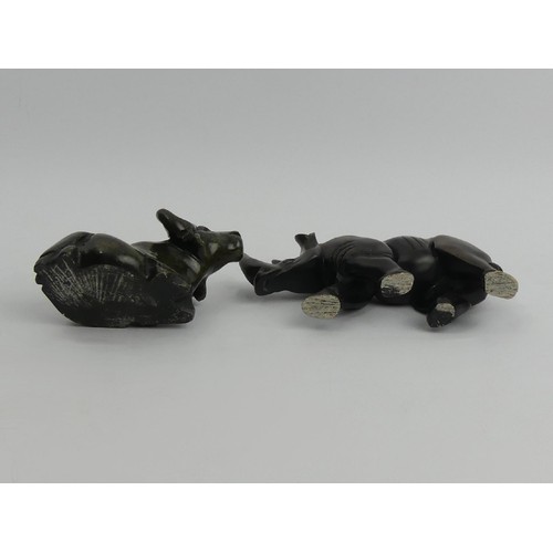 173 - A carved soapstone figure of a rhino and a soapstone figure of a water buffalo, rhino 9.5cm high x 1... 