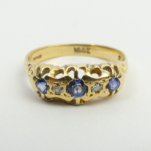 17 - 18ct gold three stone sapphire and diamond ring, 3.1 grams, 6.9mm, size O. UK postage £12.