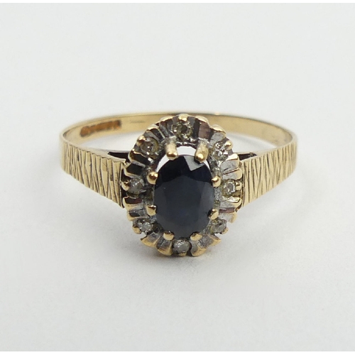 23 - 9ct gold sapphire and diamond ring, Birm. 1985, 1.8 grams, 10.2mm, size P1/2. UK postage £12.