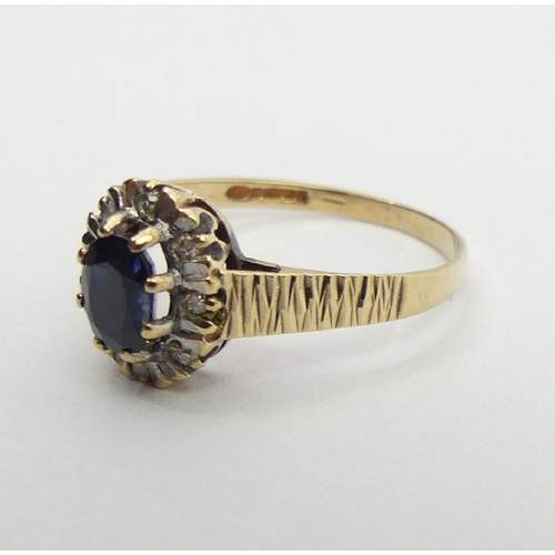 23 - 9ct gold sapphire and diamond ring, Birm. 1985, 1.8 grams, 10.2mm, size P1/2. UK postage £12.