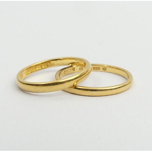 24 - Two 22ct gold wedding rings, 4.7 grams, size L & L1/2, UK postage £12.