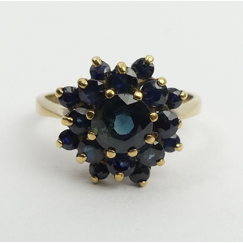 27 - 9ct gold sapphire cluster ring, Birm. 1980, 3.4 grams, 14mm, size Q. UK postage £12.