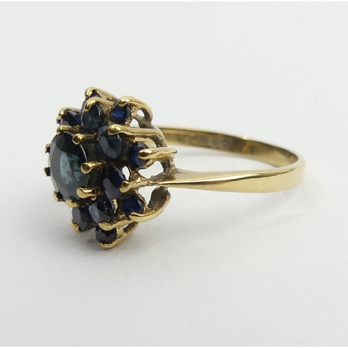 27 - 9ct gold sapphire cluster ring, Birm. 1980, 3.4 grams, 14mm, size Q. UK postage £12.