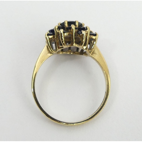 27 - 9ct gold sapphire cluster ring, Birm. 1980, 3.4 grams, 14mm, size Q. UK postage £12.