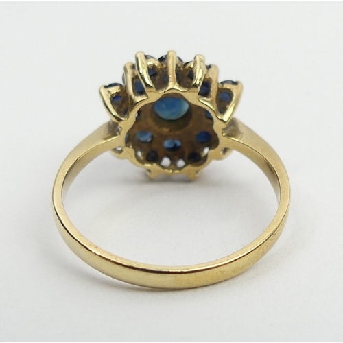 27 - 9ct gold sapphire cluster ring, Birm. 1980, 3.4 grams, 14mm, size Q. UK postage £12.