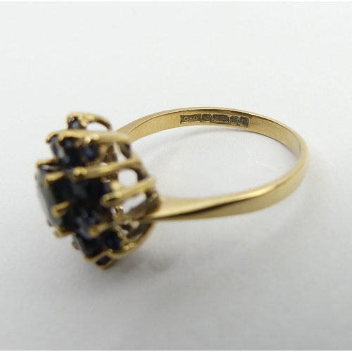 27 - 9ct gold sapphire cluster ring, Birm. 1980, 3.4 grams, 14mm, size Q. UK postage £12.