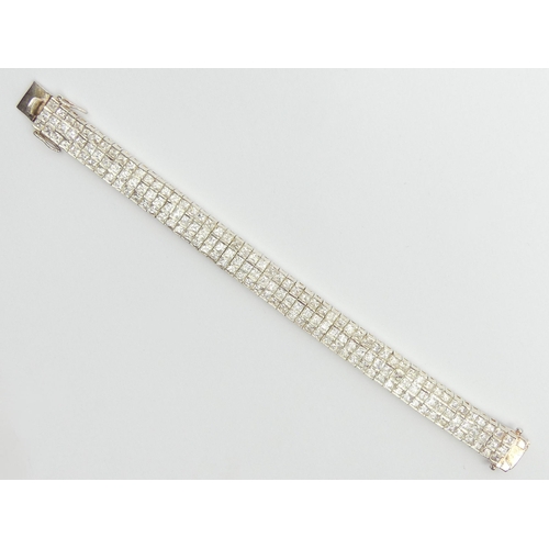 38 - Sterling silver c.z. set, three row bracelet, 51.3 grams, 18.5cm x 11.5mm. UK Postage £12.