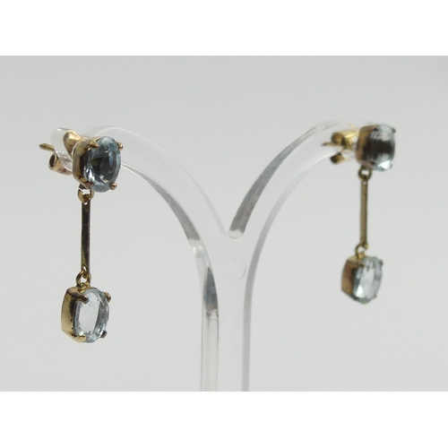 45 - A pair of 9ct gold blue topaz drop earrings, 2.5 grams, 26mm long.  UK Postage £12.