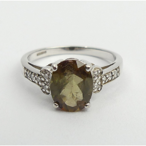 66 - 9ct white gold green citrine and diamond ring, 2.8 grams, 9mm, size N1/2. UK Postage £12.