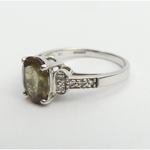 66 - 9ct white gold green citrine and diamond ring, 2.8 grams, 9mm, size N1/2. UK Postage £12.