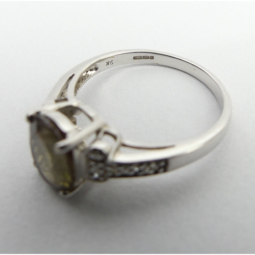 66 - 9ct white gold green citrine and diamond ring, 2.8 grams, 9mm, size N1/2. UK Postage £12.