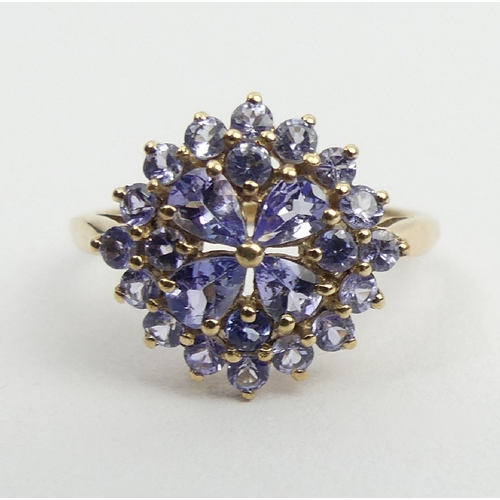 69 - 9ct gold tanzanite cluster ring, 2.2 grams, 14.3mm, size N1/2. UK Postage £12.