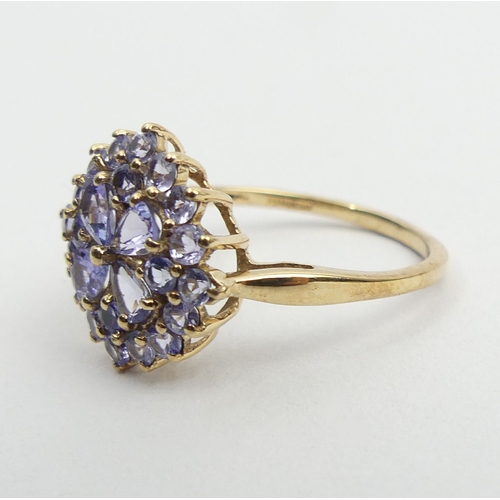 69 - 9ct gold tanzanite cluster ring, 2.2 grams, 14.3mm, size N1/2. UK Postage £12.