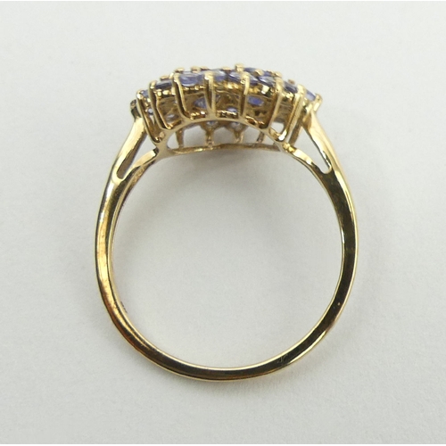 69 - 9ct gold tanzanite cluster ring, 2.2 grams, 14.3mm, size N1/2. UK Postage £12.