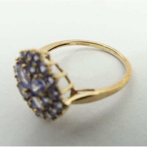 69 - 9ct gold tanzanite cluster ring, 2.2 grams, 14.3mm, size N1/2. UK Postage £12.